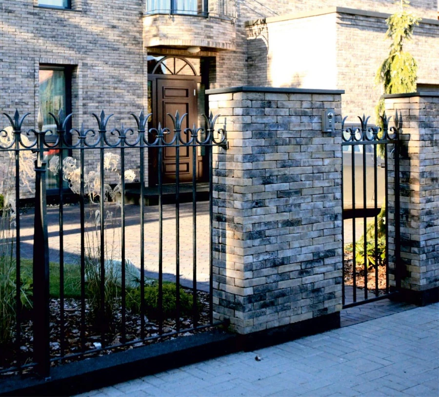 Private residence. Gates with wickets, fence, balcony railings.